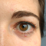 Emerald green permanent eyeliner on woman