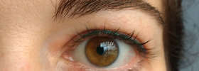 Emerald green permanent eyeliner on woman